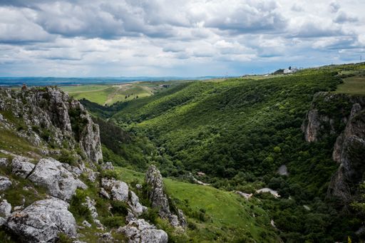 A mesmerizing view of a beautiful mountainous landscape in the cloudy sky
