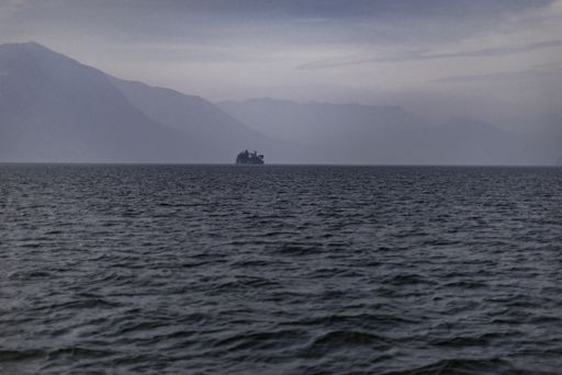 A building on the coast of Iseo lake, Italy with a foggy background