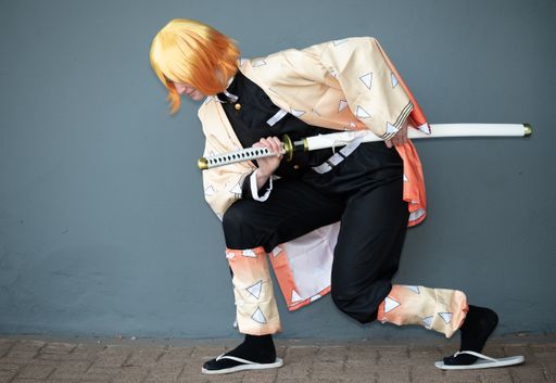 A cosplayer dressed as a samurai with orange hair