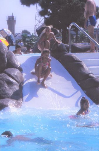 Children play on water slide in Public swimming pool in Tokyo, Japan.