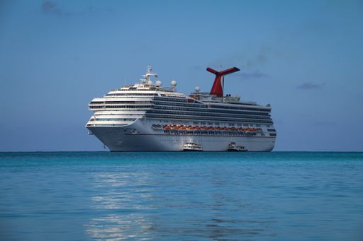 A Caribbean cruise ship docked in the ocean off the shore of Nassau City on a sunny day, The Bahamas