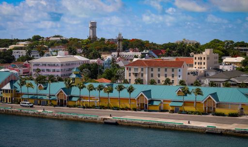 Boats docked near waterfront buildings with a clock tower in the background