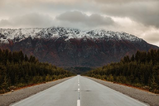 A wet asphalt road on the background of foggy mountains