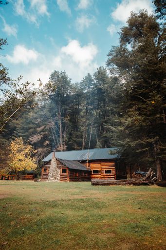 A vertical shot of a wooden country house on a sunny day