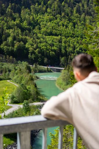A vertical shot of a man looking at the nature
