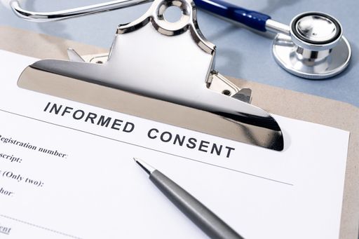 Informed Consent form and stethoscope on desk