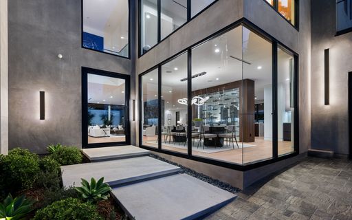 A spacious glass building with contemporary design, featuring side stairs for convenient access, New Construction Home in Tarzana, California