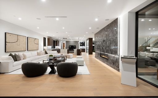 A cozy, well-furnished living room featuring stylish couches and elegant tables, New Construction Home in Tarzana, California