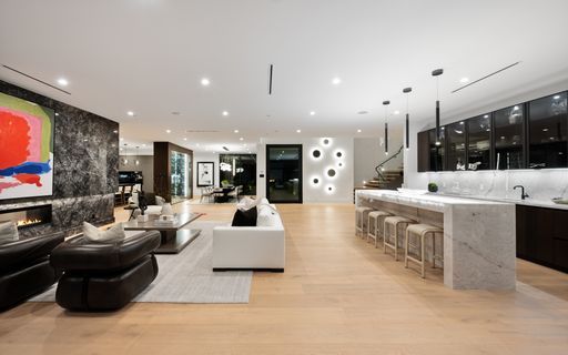An open floor plan with a contemporary design and a marble countertop. Tarzana, Los Angeles, California