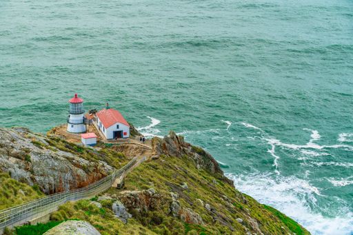 Lighthouse on rocky island by the sea