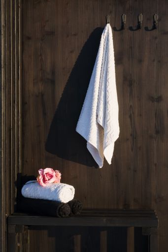 A sauna interior with towel and floral basket