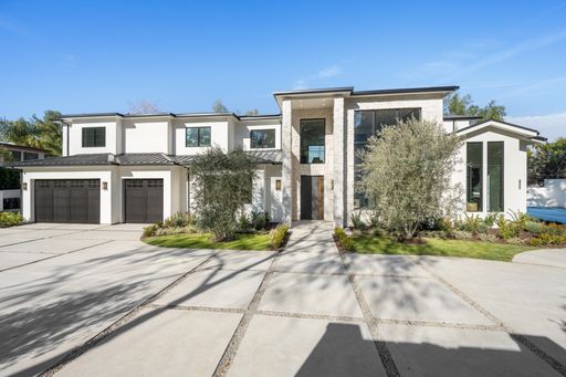 White contemporary house with well-maintained landscaping in front of the driveway, New Construction Home in Tarzana, California