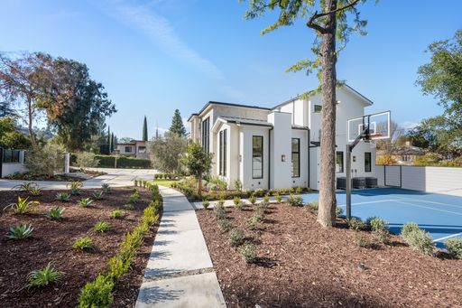 Outdoor basketball court surrounded by trees in a backyard, Tarzana, California