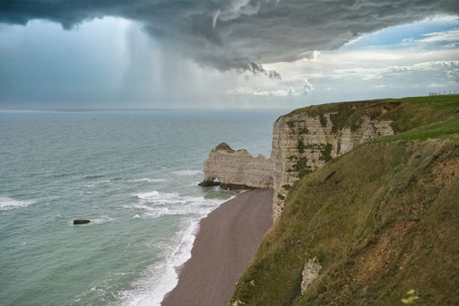 A scenic view of the famous cliffs and needle on the pebble beach at Etretat in Normandy