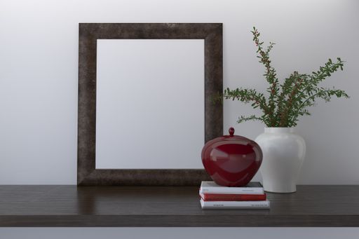 A closeup shot of a black frame with decor on the shelf