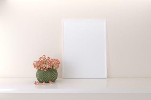 A closeup shot of a frame with decorative flowers on the shelf