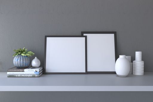 A closeup shot of frames with decorative items on a gray wall background