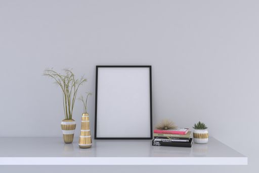 A closeup shot of a black frame with decorative items on the shelf