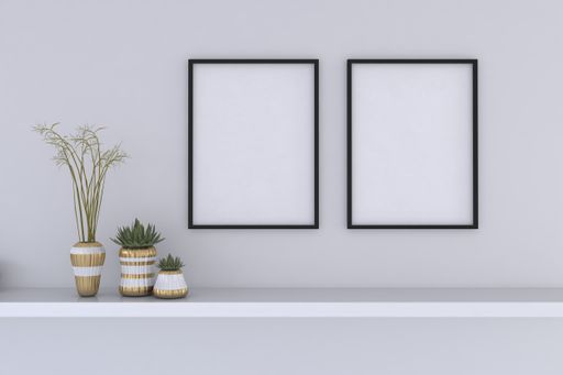 A closeup shot of black frames with decorative vases on the shelf