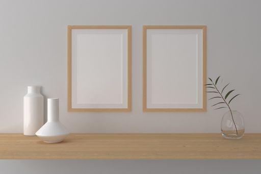 A closeup shot of frames with vases on the shelf