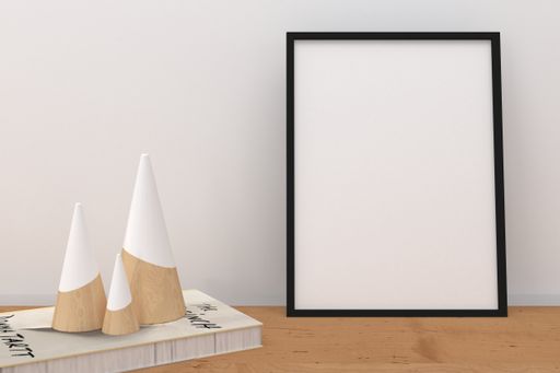 A closeup shot of a black frame with decorative items on the shelf