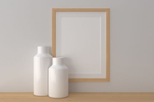 A closeup shot of a frame with vases on the shelf