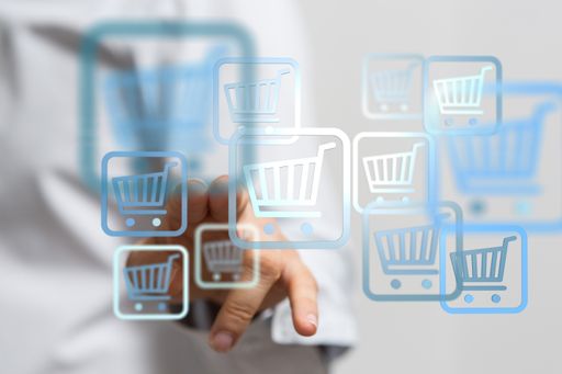 An internet marketing concept. Man with virtual trolley icons developing internet marketing strategies