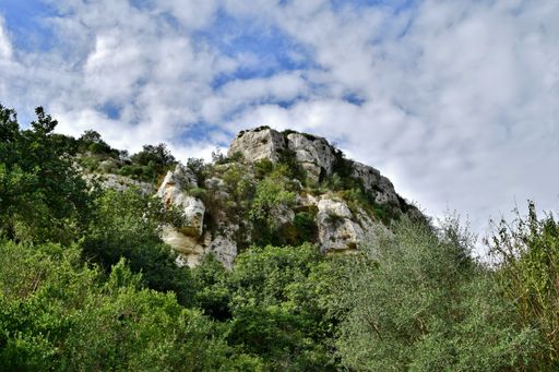 Cliff face along Cava d'Ispica canyon in Sicily, near town of Modica, famous for cave dwellings and burial archaeological remains and natural area