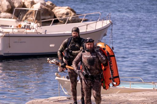 Divers fishing with harpoons in Naples, Italy, Jun 05th 2021.