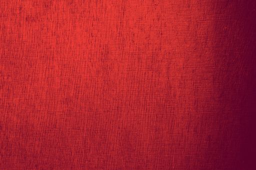 A vibrant red wall background with a wrinkled texture resembling a piece of cloth