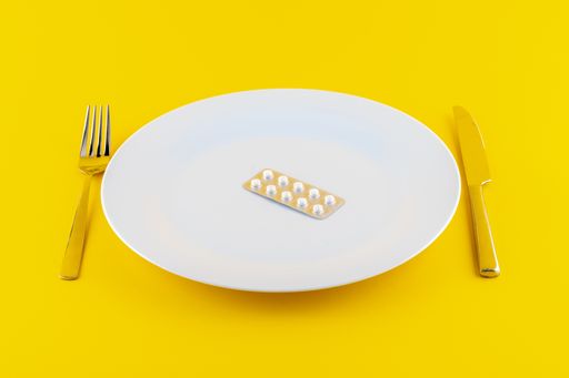 A white plate with medicine on yellow background