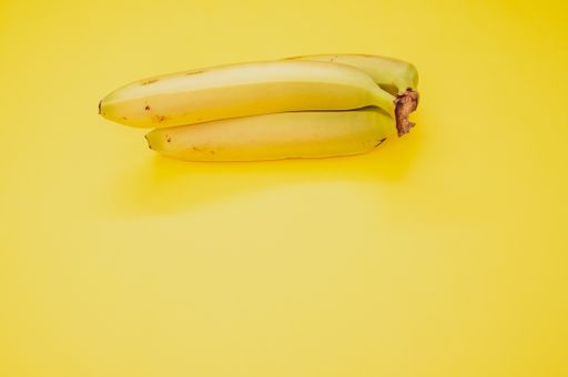 A high angl shot of ripe bananas isolated on yellow background