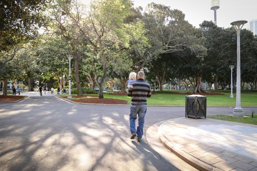 A father walking while holding his son in his hands