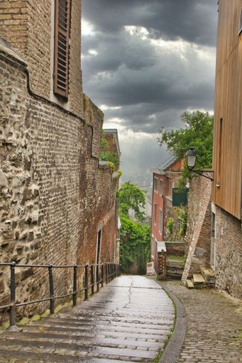 Liege, Belgium, June 2021: Au Peri street view in Liege with staircase on a rainy day.