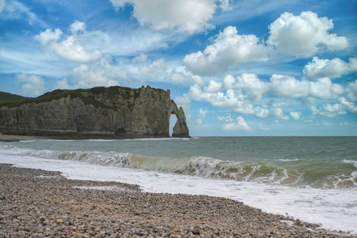 A beautiful shot of Etretat in Normandy, the famous cliffs and needle on the pebble beach