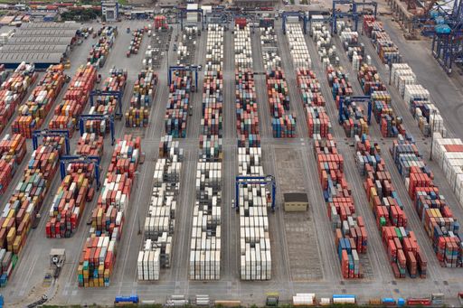 aerial view of port yard full of containers awaiting boarding on ships
