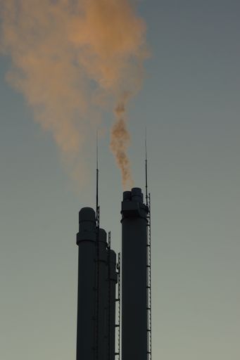 A vertical shot of chimneys of a gas power plant in Marburg, Germany, supplying a significant portion of heating