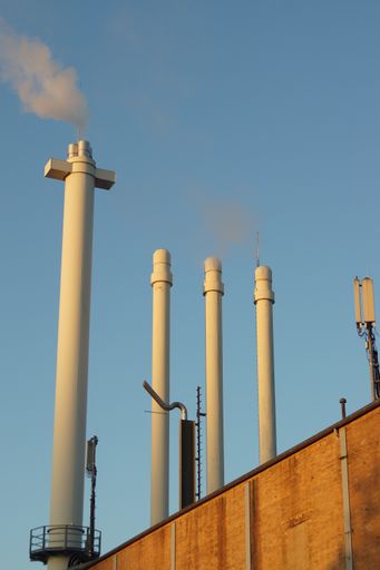 A vertical shot of chimneys of a gas power plant in Marburg, Germany, supplying a significant portion of heating