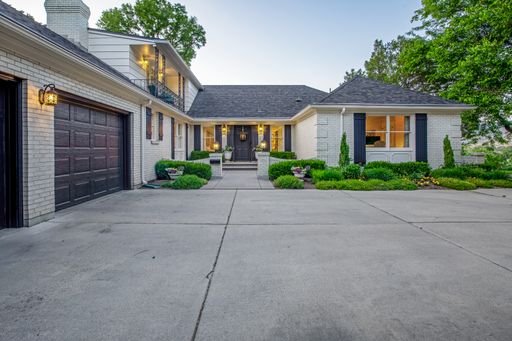 Spacious suburban home with attached garage and ample windows in a desirable neighborhood