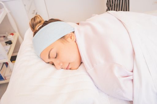 A young Hispanic female laying down for a facial at a spa