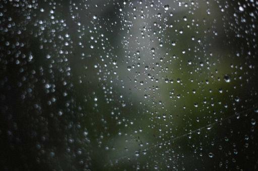 A selective focus shot of raindrops on the window after the rain