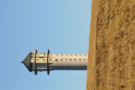 A vertical shot of historic Feldberg Tower, an observation deck in Feldberg, Germany against blue sky