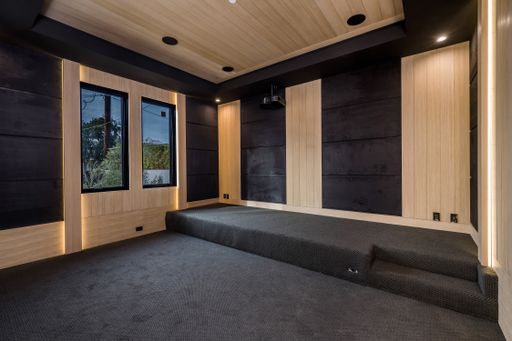 A spacious bedroom features dual staircases leading to the entrance