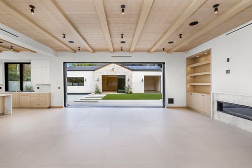Open white house with stylish hardwood wall accents
