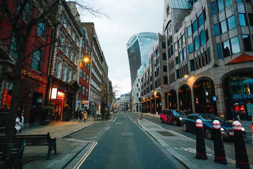 The cars driving on a bustling city street in downtown London