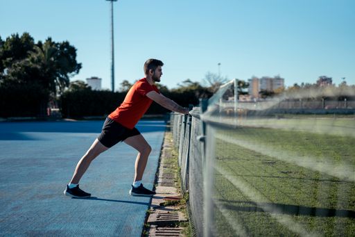 A Caucasian man working out outdoors on a sunny day