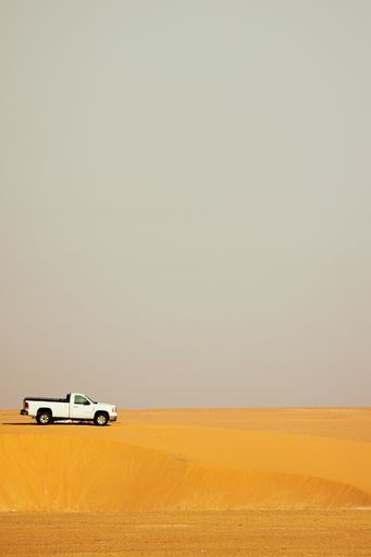 A pickup truck in a desert landscape