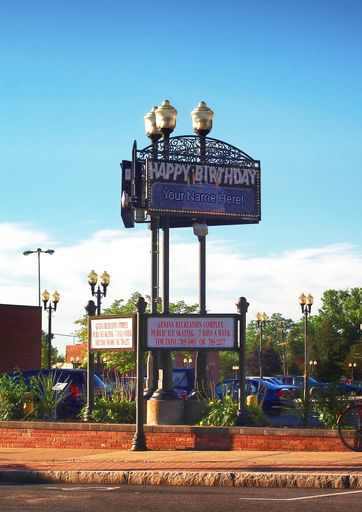 Public birthday announcement sign in downtown Geneva, New York on a quiet summer morning