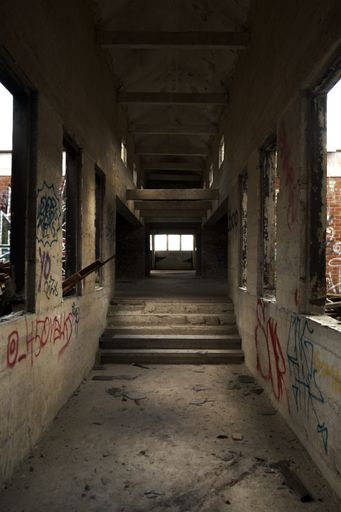 Colorful graffiti covering the walls and floor of an urban abandoned factory