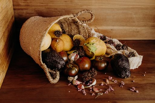 A closeup shot of gourmet dried fruits and vegetables pouring out of a basket
